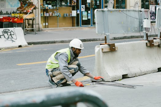 pexels-photo-448828-448828 A construction worker operates on a city street in Paris, France, showcasing urban development.